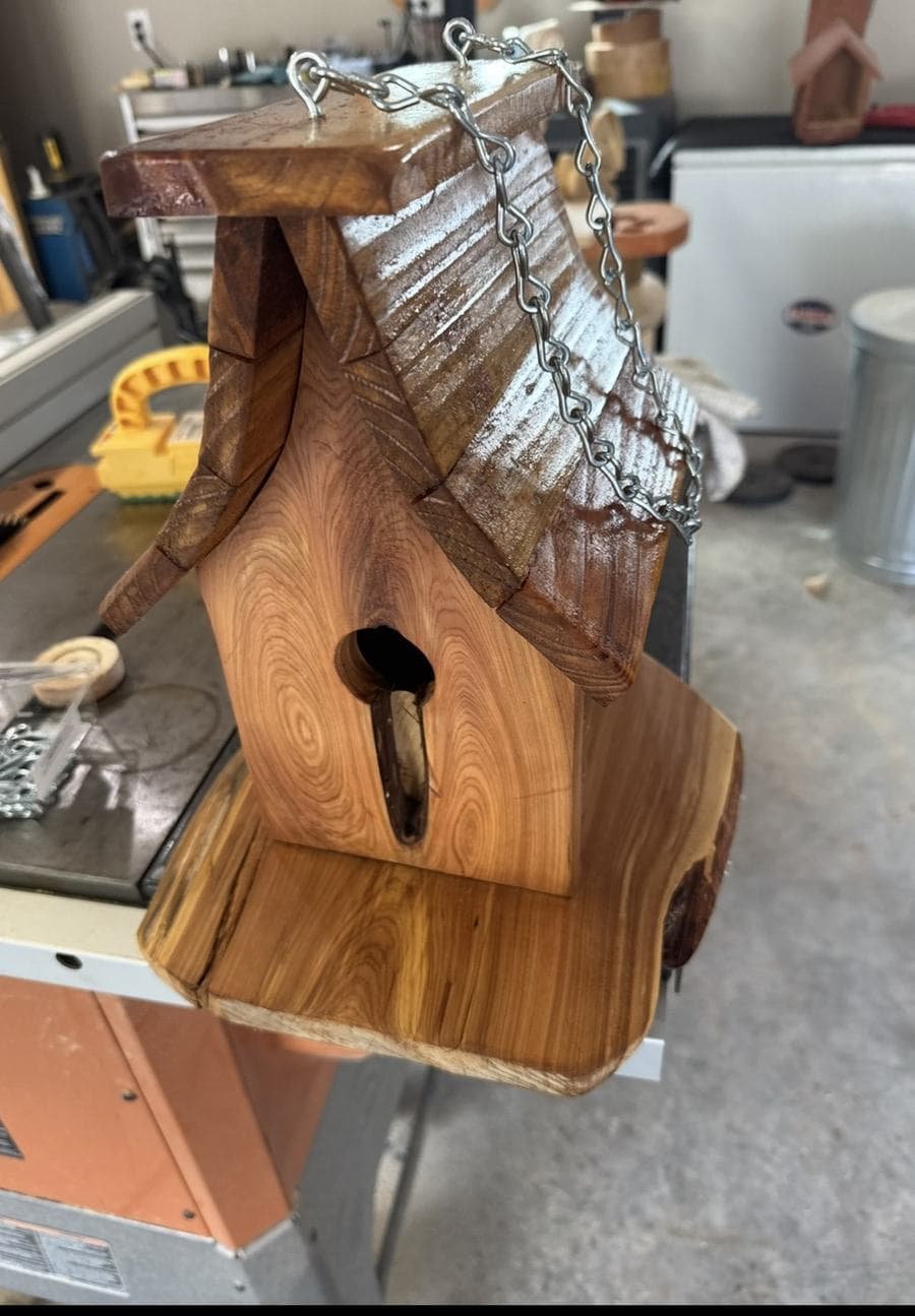 Handmade cedar birdhouse with shingled roof