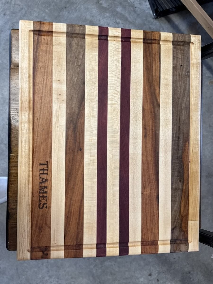 Multi-wood cutting board with engraved name